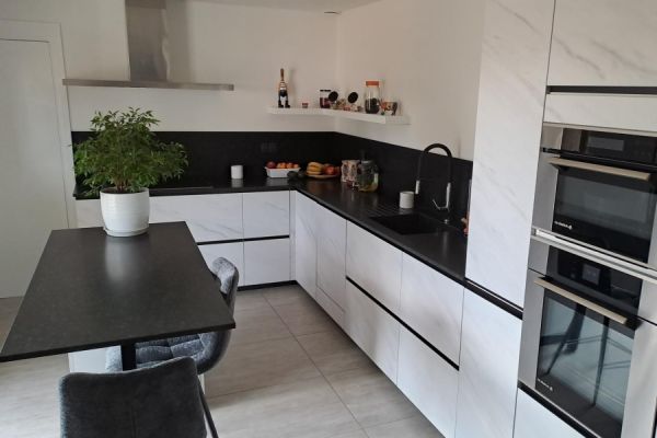 Cuisine avec du granit noir et des poignées intégrées, une cuisine réalisée par SoCoo'c Roanne